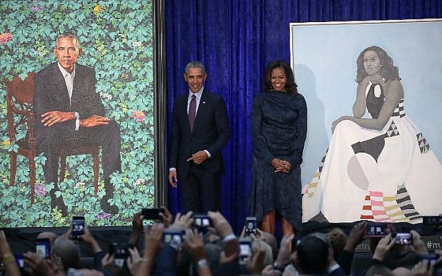 Former US president Barack Obama and former first lady Michelle Obama stand next to their newly unveiled portraits during a ceremony at the Smithsonian's National Portrait Gallery, on February 12, 2018 in Washington, DC. (Mark Wilson/Getty Images/AFP)