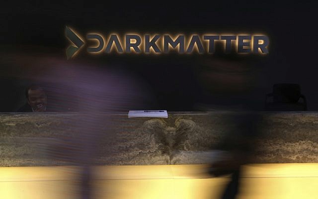 In this January 30, 2018 photo, taken with a long exposure, employees walk into offices of the cybersecurity firm DarkMatter, in Abu Dhabi, United Arab Emirates. DarkMatter, a growing cybersecurity company that’s recruited Western intelligence analysts, is slowly stepping out of the shadows amid activist concerns about its power. (AP Photo/Jon Gambrell)