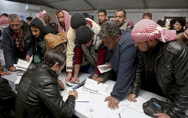 Syrian refugees register their names at an employment office, February 18, 2018, at the Azraq Refugee Camp, 100 kilometers (62 miles) east of Amman, Jordan. (AP Photo/Raad Adayleh)
