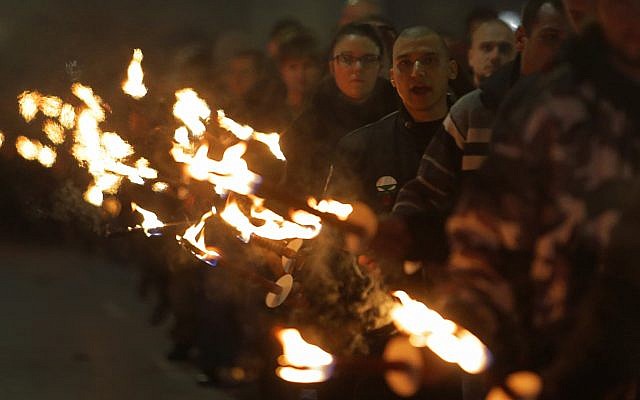 Far-right activists march with torches during a march to commemorate pro-Nazi Bulgarian general Hristo Lukov in Sofia on February 17, 2018. (AP Photo/Valentina Petrova)