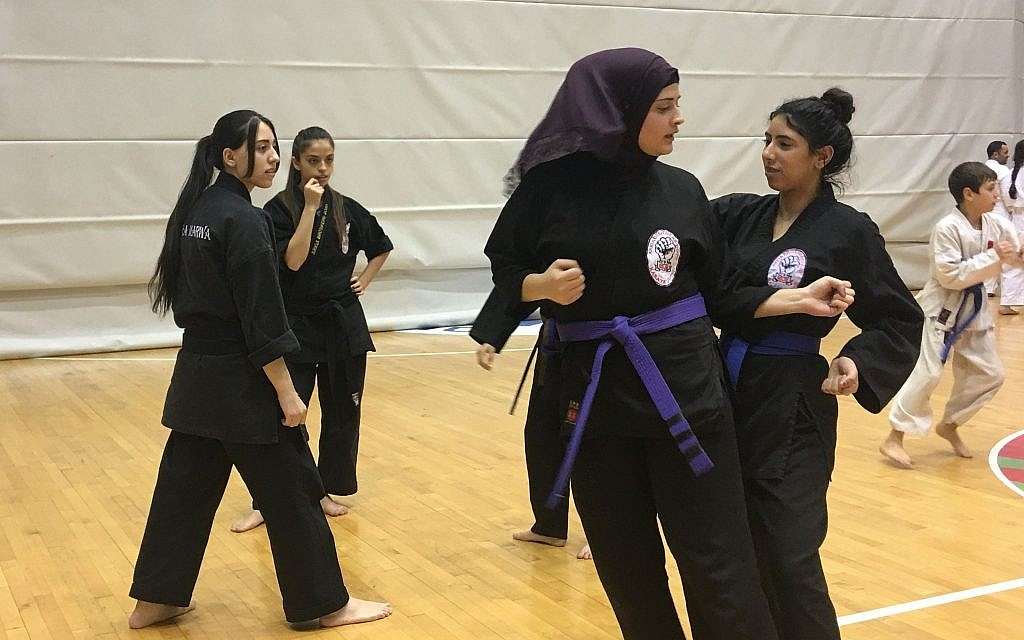 Two young students practicing martial arts techniques during the Budo for Peace Seminar, February 13, 2018 (Urvashi Verma/Times of Israel)