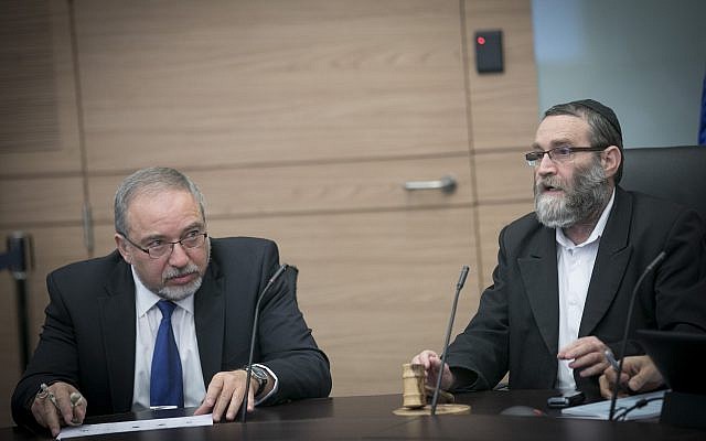 Defense Minister Avigdor Liberman (L) and United Torah Judaism MK Moshe Gafni at a Knesset Finance Committee meeting on December 6, 2016. (Yonatan Sindel/Flash90)