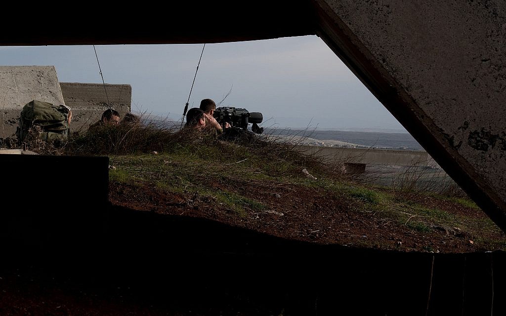 Israeli soldiers survey the border with Syria from a military post in the Golan Heights, following a series of aerial clashes with Syrian and Iranian forces in Syria, on February 10, 2018. (Flash90)