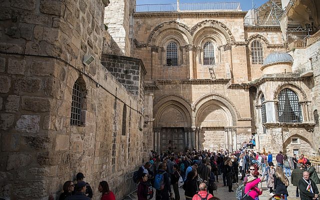 People gather outside the closed doors of the Church of the Holy Sepulchre in Jerusalem's Old City on February 25, 2018. (Hadas Parush/Flash90)