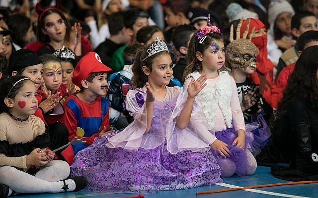Young Israeli children dressed up in costumes for the Jewish holiday of Purim at a school in northern Israel, on February 27, 2018.  (Anat Hermony/Flash90)