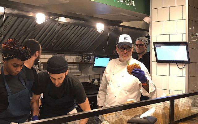Israeli chef Eyal Shani prepares a pita in the newly-opened New York branch of his Miznon restaurant chain. (Danielle Ziri/Times of Israel)