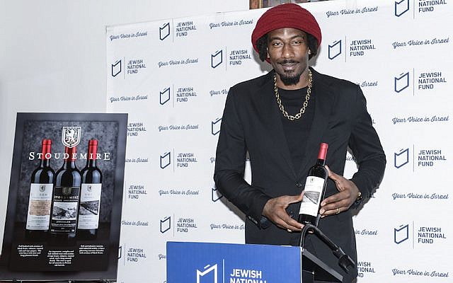 Amar’e Stoudemire showing one of the wines in his collection of Israeli kosher wines, in New York, February 20, 2018. (Courtesy of Jewish National Fund-USA via JTA)