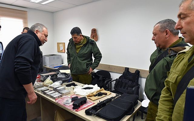 Defense Minister Avigdor Liberman, left, inspects a guns and military gear seized in an IDF operation in Hebron, along with the top military liaison to the Palestinians Maj. Gen. Yoav Mordechai, center, IDF chief Gadi Eisenkot, center-right and outgoing head of the IDF's Central Command Maj. Gen. Roni Numa, right, during a tour of Hebron on February 27, 2018. (Ariel Hermoni/Defense Minister)
