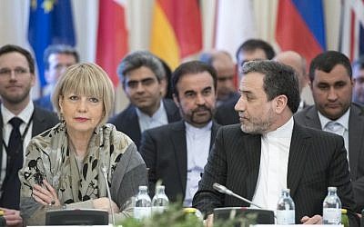 Abbas Araghchi (R), political deputy at the Ministry of Foreign Affairs of Iran, and the Secretary General of the European Union External Action Service (EEAS) Helga Schmid attend E3/EU+3 and Iran talks at Palais Coburg in Vienna, Austria on March 16, 2018. (AFP/Joe Klamar)