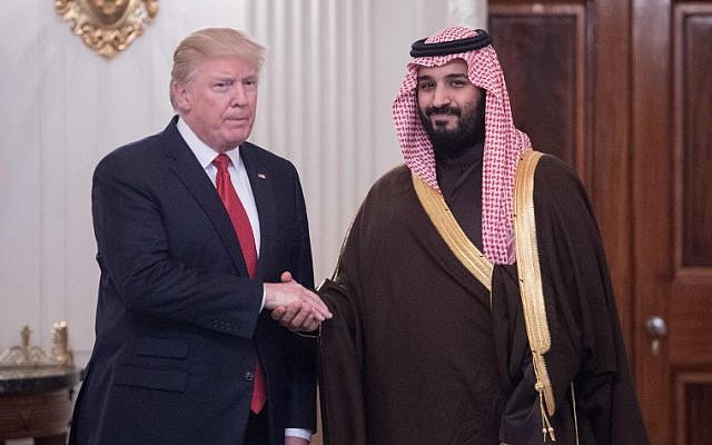 This photo taken on March 14, 2017 shows US President Donald Trump and Saudi Deputy Crown Prince and Defense Minister Mohammed bin Salman shaking hands in the State Dining Room before lunch at the White House in Washington, DC. (AFP PHOTO / NICHOLAS KAMM)