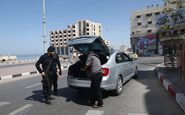 Illustrative: Hamas police inspect the trunk of a car at a checkpoint amid tightened security around Gaza city on March 22, 2018. (AFP/Mohammed Abed)