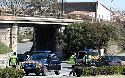 French gendarmes block access to Trebes, where a man took hostages at a supermarket on March 23, 2018 in Trebes, southwest France. (AFP Photo/Eric Cabanis)