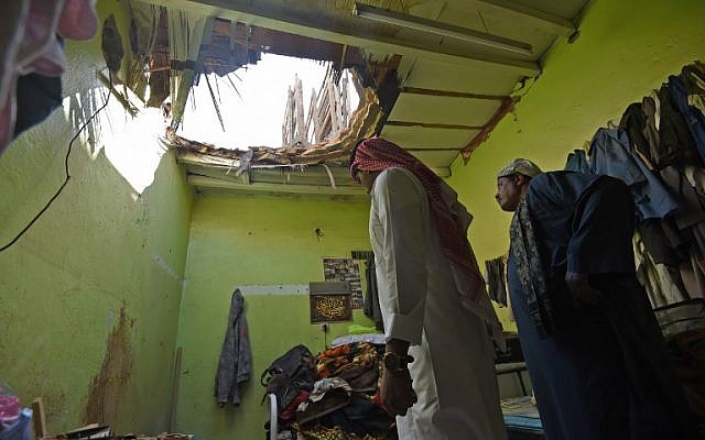 A picture taken March 26, 2018 in Um Al-Hammam district in Riyadh shows Egyptian laborers inspecting damages to a home hit by falling shrapnel from Yemeni rebel missiles that were intercepted over the Saudi capital. (AFP PHOTO / FAYEZ NURELDINE)