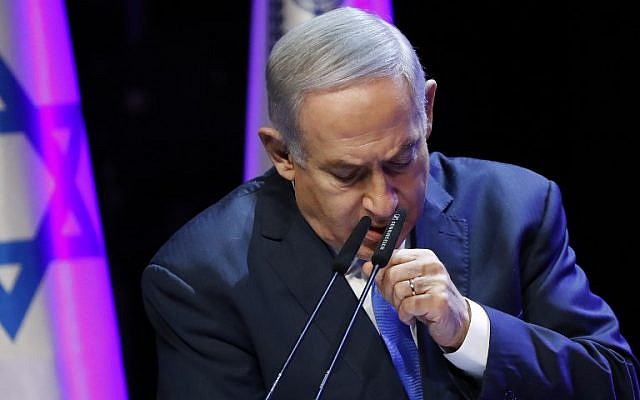 Prime Minister Benjamin Netanyahu coughing while addressing an annual health conference in Tel Aviv on March 27, 2018.  (AFP / JACK GUEZ)