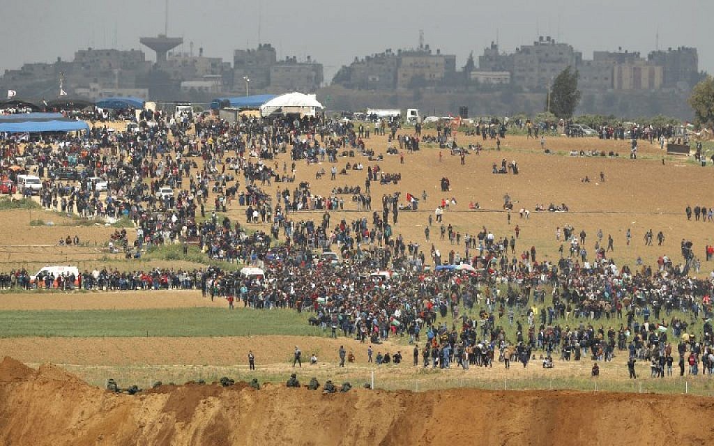 A picture taken on March 30, 2018 from the southern Israeli kibbutz of Nahal Oz across the border from the Gaza strip shows Palestinians participating in a tent city protest. (AFP/Jack Guez)