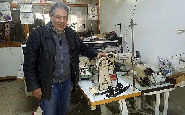 In this photo dated February 28, 2018, Ennahdha party candidate in the May municipal elections Simon Slama poses in his sewing machine repair shop in Monastir, Tunisia. (AP Photo/Mehdi Arem)