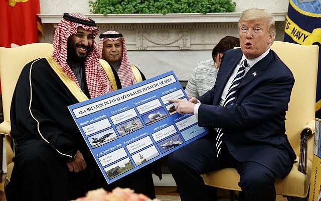 US President Donald Trump shows a chart highlighting arms sales to Saudi Arabia during a meeting with Saudi Crown Prince Mohammed bin Salman in the Oval Office of the White House, March 20, 2018. (AP Photo/Evan Vucci)