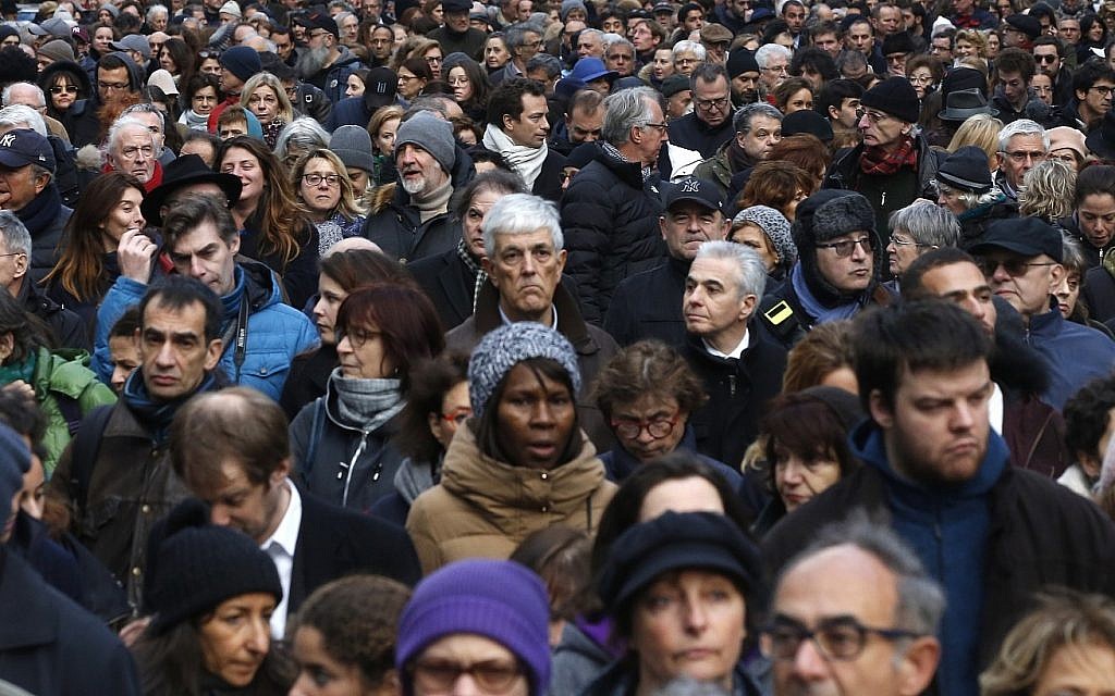 People attend a silent march to honor an 85-year-old woman who escaped the Nazis 76 years ago but was stabbed to death last week in her Paris apartment, apparently targeted because she was Jewish, and to denounce racism, in Paris, France, Wednesday, March 28, 2018. (AP Photo/Thibault Camus)