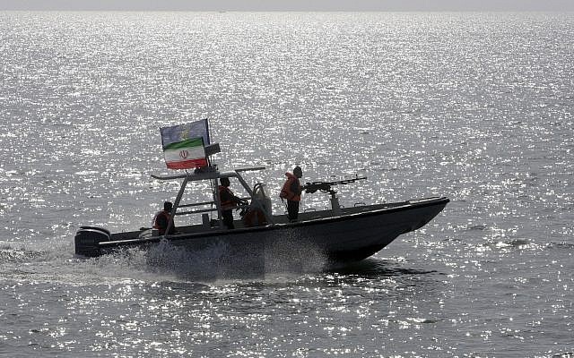 In this Monday, July 2, 2012 file photo, an Iranian Revolutionary Guard speedboat escorts a passenger ship, unseen, near the spot where an Iranian airliner was shot down by a U.S. warship 24 years ago killing 290 passengers. (AP/Vahid Salemi, File)