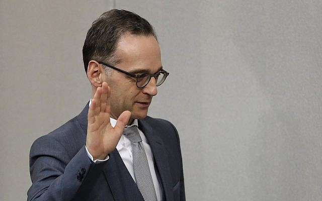 German Foreign Minister Heiko Maas takes the oath of office after the new government was appointed after German Chancellor Angela Merkel was elected for a fourth term as chancellor in the German parliament Bundestag in Berlin, Germany, Wednesday, March 14, 2018. (AP Photo/Michael Sohn)