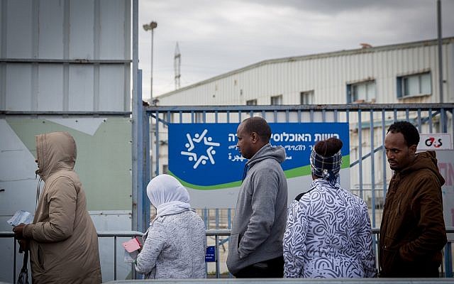 Illustrative photo of asylum seekers waiting outside the Israeli Population and Immigration Authority office waiting to find out their status, in Bnei Brak, Israel, February 13, 2018. (Miriam Alster/FLASH90)