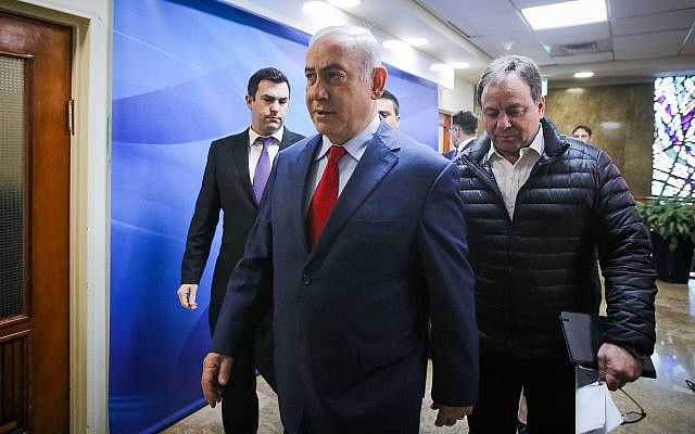 Prime Minister Benjamin Netanyahu (C) arrives at the weekly cabinet meeting at the Prime Minister's Office in Jerusalem on March 11, 2018. (Marc Israel Sellem/Pool)
