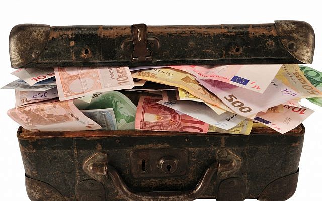 Illustrative image of a suitcase full of cash (ungorf; iStock by Getty Images)