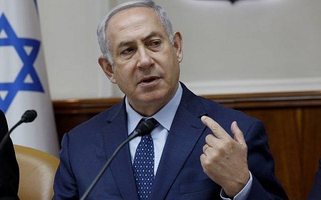 Israeli Prime Minister Benjamin Netanyahu gestures at the start of the weekly cabinet meeting at the Prime Minister's office in Jerusalem April 15, 2018. (AFP/Gali Tibbon)