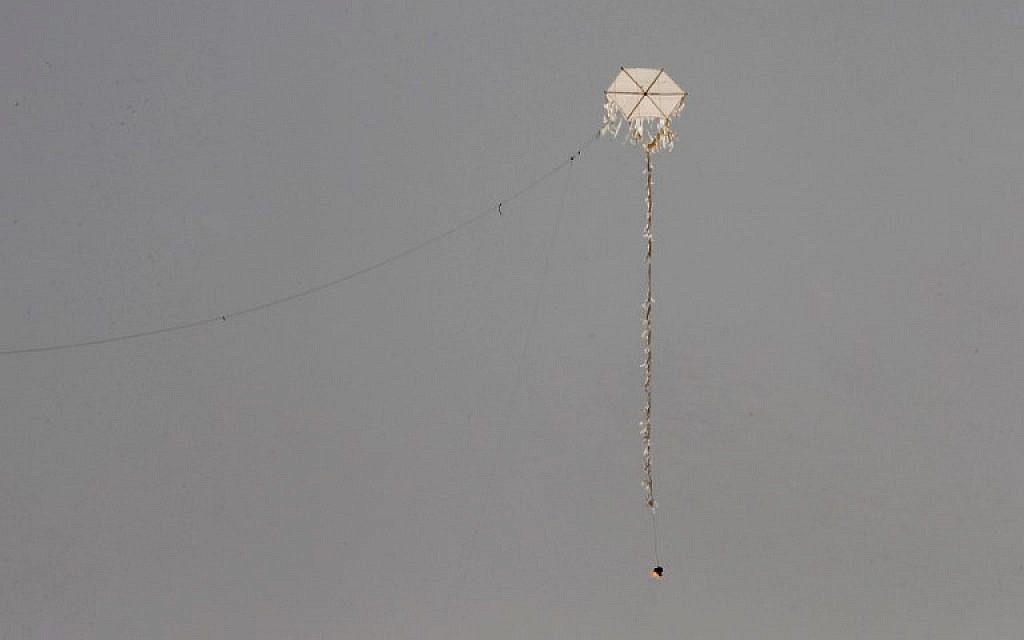 A kite with a firebomb attached to it is flown by Palestinian protestors towards the border fence with Israel, in Rafah in the southern Gaza Strip, on April 20, 2018. (AFP Photo/Said Khatib)