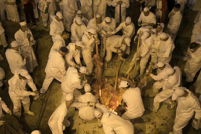 Samaritans take part in the traditional Passover sacrifice ceremony, where sheep and goats are slaughtered, at Mount Gerizim near the northern West Bank city of Nablus on April 29, 2018. (AFP)