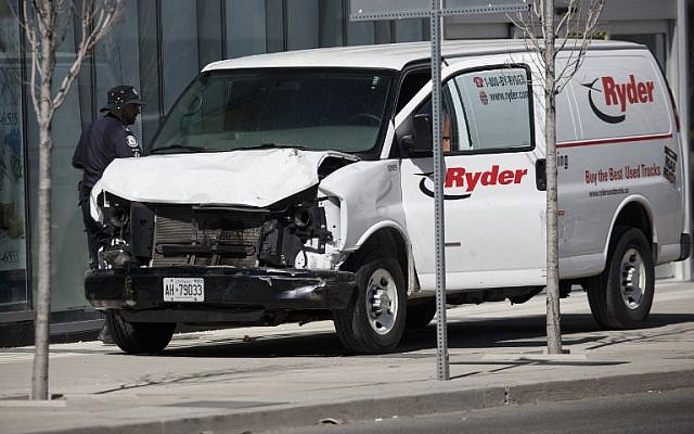 Police inspect a van suspected of being involved in a collision killing 10 people at Yonge St. and Finch Ave. on April 23, 2018, in Toronto, Canada. (Cole Burston/Getty Images/AFP)