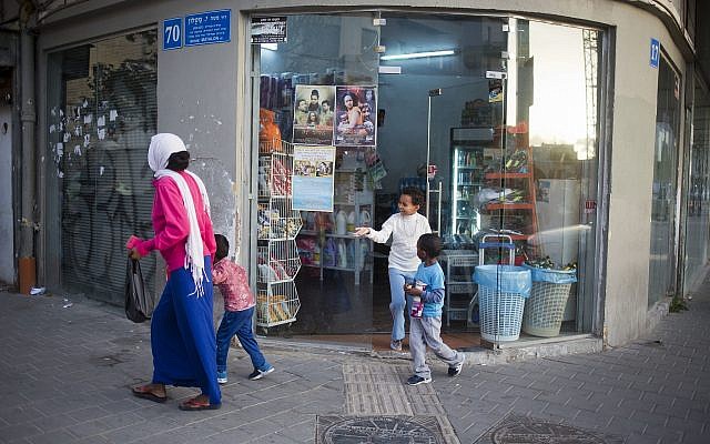 In this Tuesday, April 3, 2018 photo, A family of African migrants go shopping in southern Tel Aviv. (AP Photo/Ariel Schalit)