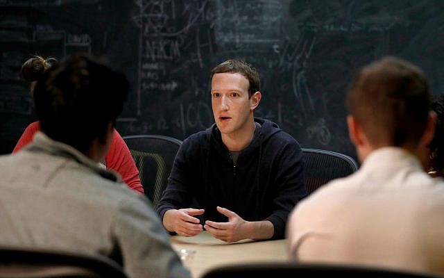 In this Nov. 9, 2017 photo, Facebook CEO Mark Zuckerberg meets with a group of entrepreneurs and innovators. (AP Photo/Jeff Roberson, File)