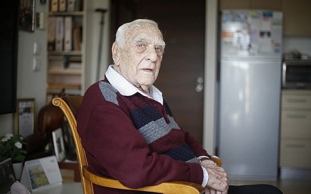 In this Tuesday, April 10, 2018 photo, Baruch Shub, a Holocaust survivor, poses for a photo at his apartment in a senior citizens’ home in Kfar Saba, Israel. (AP Photo/Ariel Schalit)