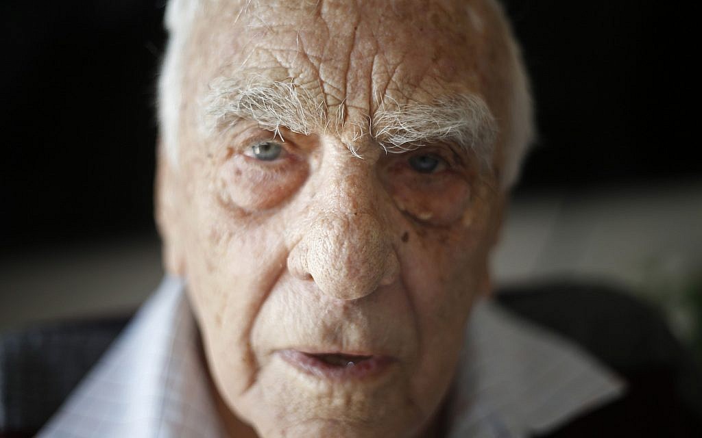 In this Tuesday, April 10, 2018 photo, Baruch Shub, a Holocaust survivor, poses for a photo at his apartment in a senior citizens' home in Kfar Saba, Israel. (AP Photo/Ariel Schalit)
