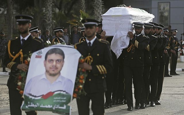 Hamas terror group members carry the coffin of Palestinian rocket and drone expert Fadi al-Batsh after his remains crossed into the Gaza Strip from Egypt April 26, 2018. (Khalil Hamra/AP)