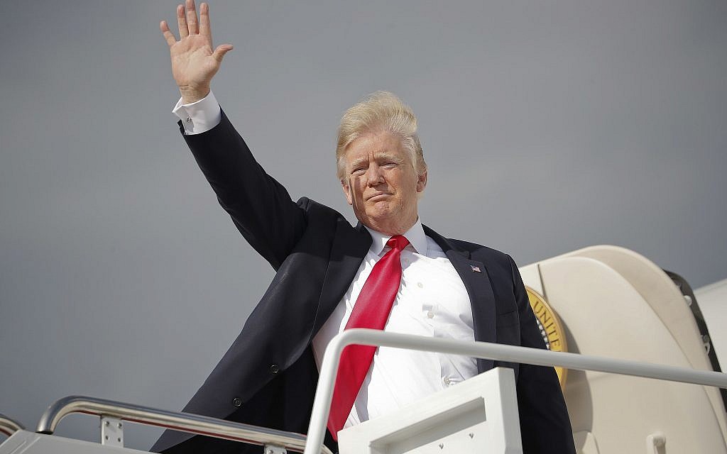 US President Donald Trump waves as he boards Air Force One during his departure from Andrews Air Force One Base, Md., April 28, 2018. (Pablo Martinez Monsivais/AP)