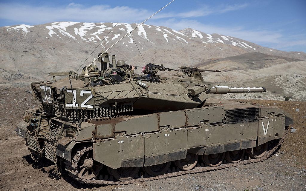 File: Israeli soldiers peer into Syria from their tank on the Golan Heights on February 18, 2016. (Ariel Schalit/AP Photo)
