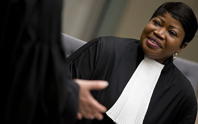 Public Prosecutor Fatou Bensouda, right, waits for alleged jihadist leader Al Hassan Ag Abdoul Aziz Ag Mohamed Ag Mahmoud to enter the court room for his initial appearance on charges of war crimes and crimes against humanity at the International Criminal Court in The Hague, Netherlands, Wednesday, April 4, 2018. After his capture in Mali, the court in The Hague said that Al Hassan allegedly committed the crimes in Timbuktu while the town was under the control of extremists between April 2012 and January 2013. (AP Photo/Peter Dejong, Pool)