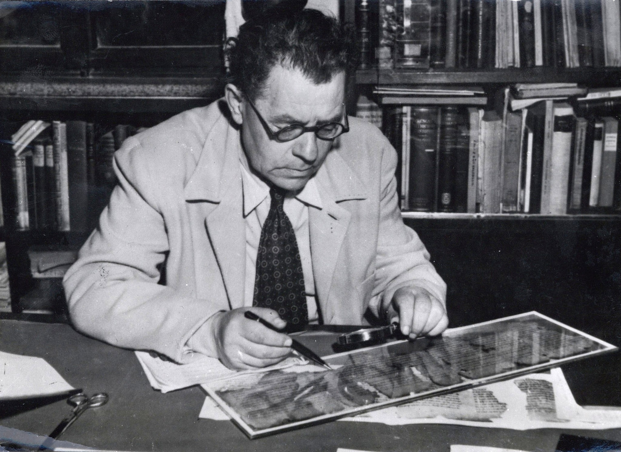 A 1951 image of the Hebrew University's Prof. Eleazar Sukenik with one of the Dead Sea Scrolls. (Department of Archaeology, the Hebrew University, Jerusalem - National Library of Israel, Schwadron collection)