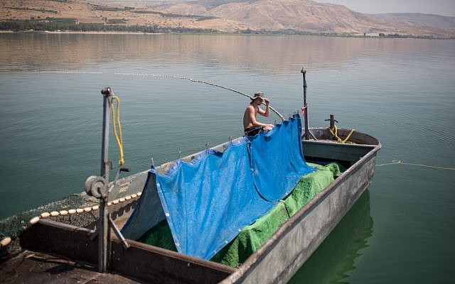 Illustrative: Fishermen from the kibbutz Ein Gev, seen on the fishing boat "Gil," on the Sea of Galilee, Northern Israel.May 7, 2017. (Maor Kinsbursky/FLASH90)