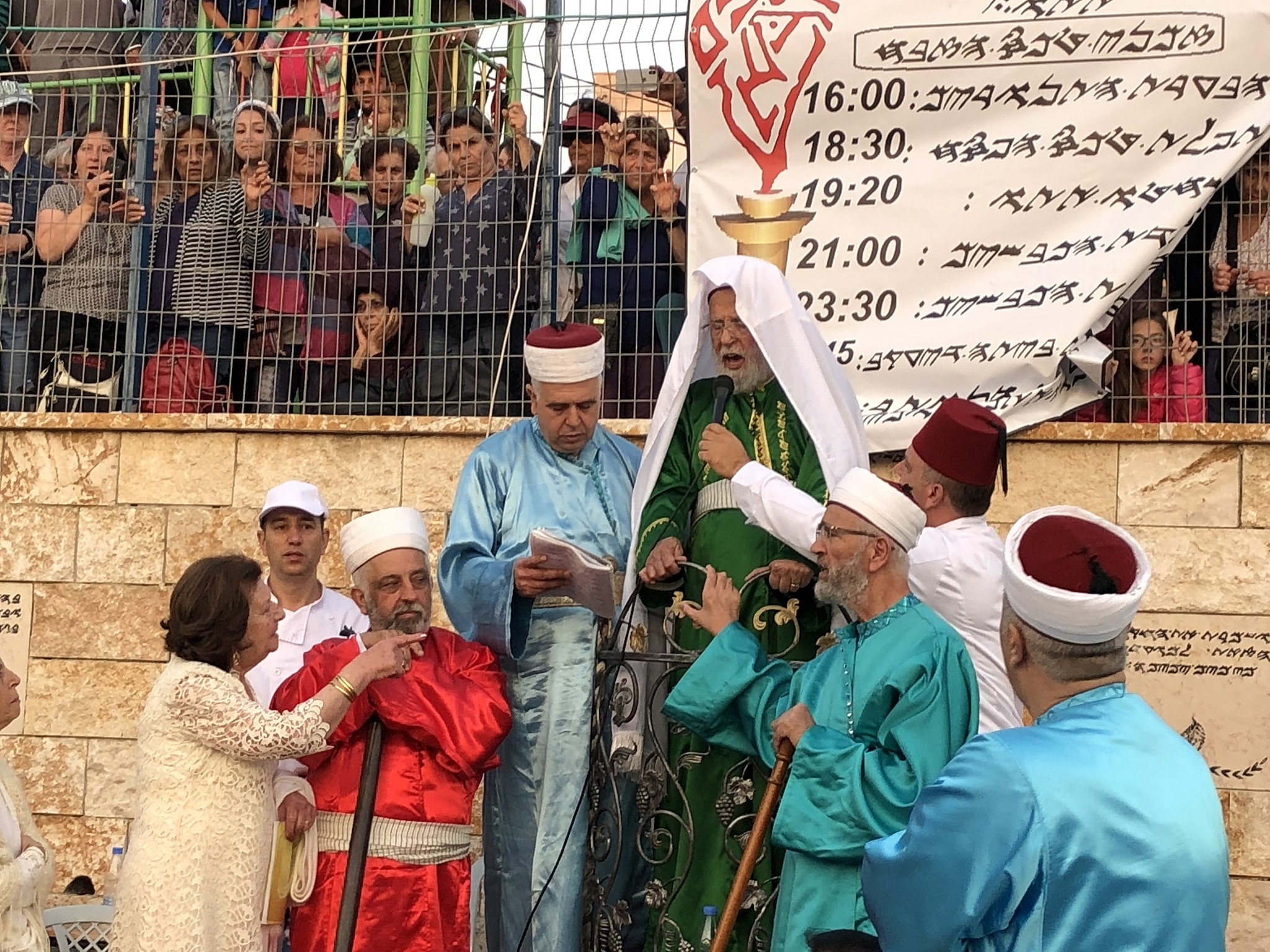 The Samaritan high priest (green garb) leads his tribe in the traditional Passover sacrifice ceremony, where sheep and goats are slaughtered, at Mount Gerizim near the northern West Bank city of Nablus on April 29, 2018. (Jacob Magid/Times of Israel)