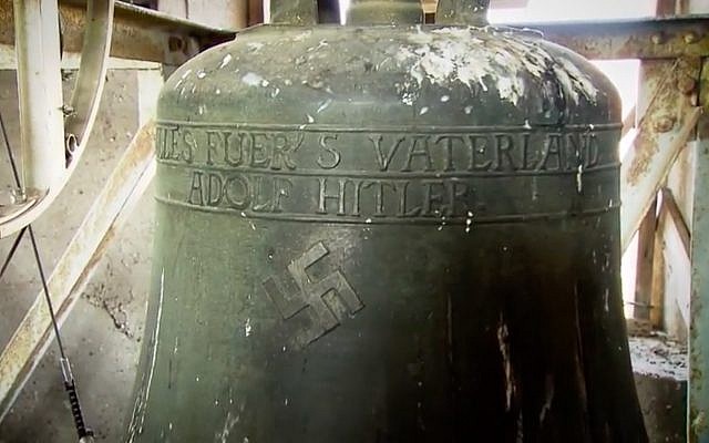 A swastika emblazoned on a bell in a church in the German town of Schweringen. (Screen capture/YouTube)