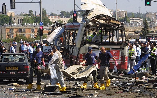 Paramedics and police at the scene of a Palestinian suicide-bombing that killed 19 and injuring 74 on a bus in Jerusalem, June 18, 2002. (Flash90/File)
