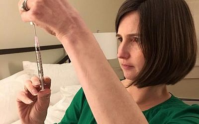Carrie Bornstein of Boston prepares for an injection during her surrogate pregnancy for a British-Jewish couple living in London, 2017 (courtesy)