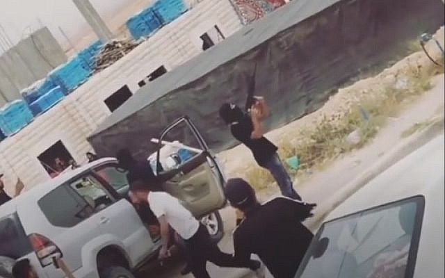 Bedouins seen shooting M-16s into the air on April 20, 2018, during a wedding procession near Ohalim Junction on Route 40. (Screencapture)