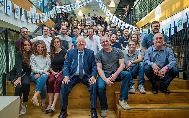 President Reuven Rivlin, left, with Waze CEO Noam Bardin, right, and the Waze team ahead of Israel's Independence Day celebrations, in April 2018. Waze featured President Rivlin's recorded driving tips for Independence Day revelers. (Victor Levy)