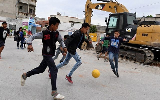 Children play football in the streets of Ettadhamen city on April 30, 2018, an impoverished area of Greater Tunis.(AFP/ FETHI BELAID)