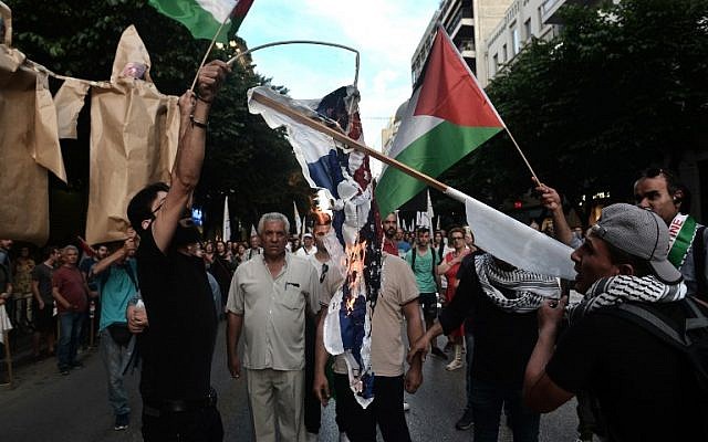 Palestinians who live in Thessaloniki burn USA and an Israeli flags in front of the US consulate during a demonstration on May 17, 2018, to denounce the bloodshed along the Gaza border and the relocation of the US embassy to Jerusalem.  (AFP/Sakis MITROLIDIS)