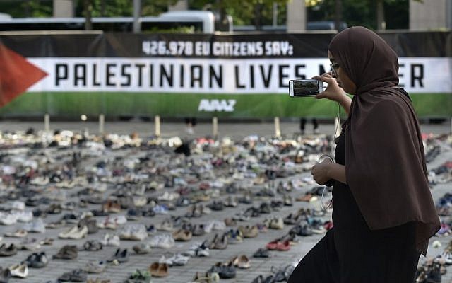 A woman takes a picture of an installation set up by a global civic organization Avaaz ahead of the EU council meeting in Brussels on May 28, 2018. (AFP PHOTO / JOHN THYS)